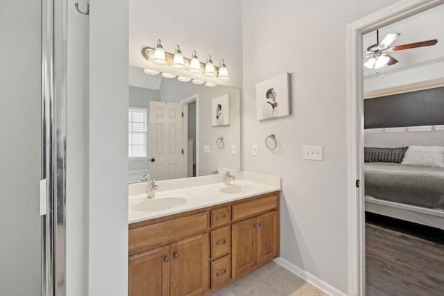 bathroom with ceiling fan, tile patterned flooring, and vanity