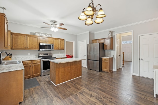 kitchen featuring stainless steel appliances, dark hardwood / wood-style flooring, a center island, sink, and crown molding