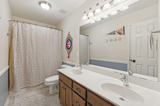 bathroom featuring tile patterned flooring, vanity, and toilet