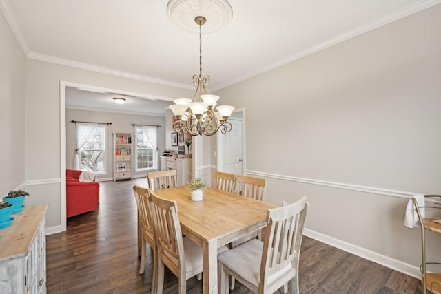 dining room featuring dark hardwood / wood-style flooring, crown molding, and an inviting chandelier