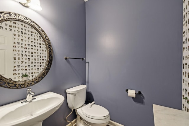 bathroom featuring sink and toilet