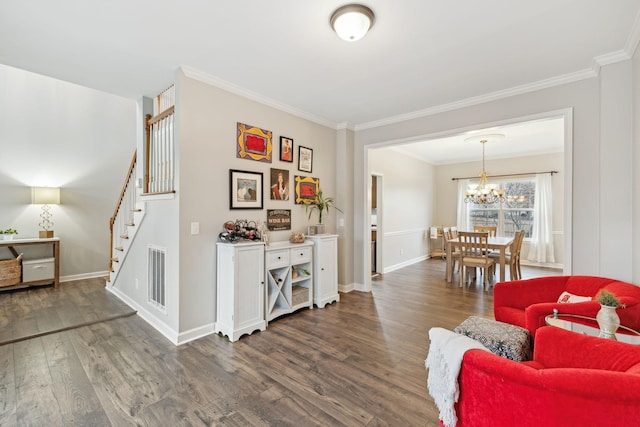 living area featuring a notable chandelier, dark hardwood / wood-style floors, and ornamental molding