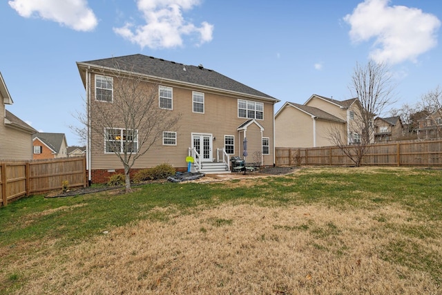 rear view of property featuring a lawn