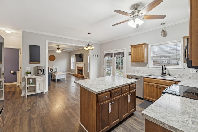 kitchen featuring hanging light fixtures, stainless steel appliances, dark hardwood / wood-style flooring, a kitchen island, and sink