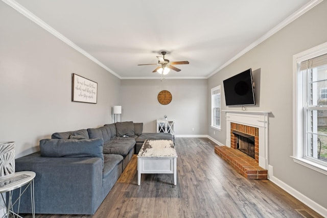 living room featuring a fireplace, crown molding, dark hardwood / wood-style flooring, and a healthy amount of sunlight