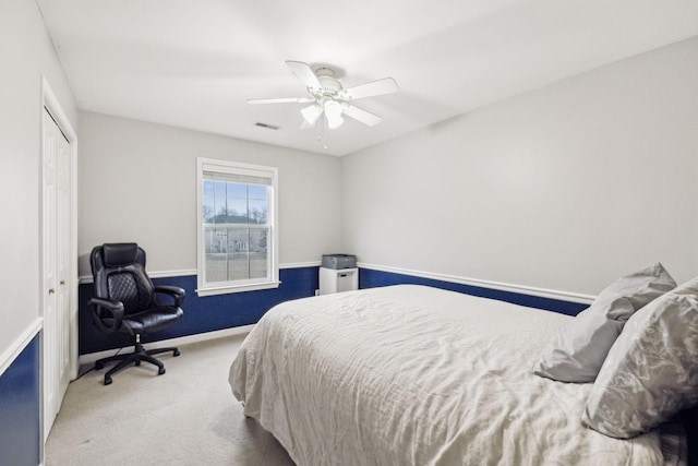 carpeted bedroom featuring a closet and ceiling fan