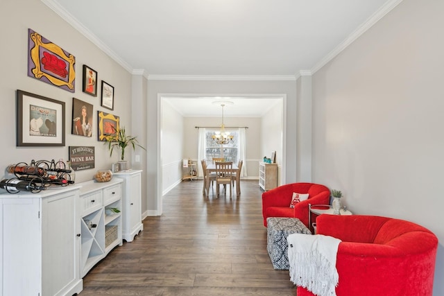 sitting room with crown molding, dark hardwood / wood-style floors, and an inviting chandelier