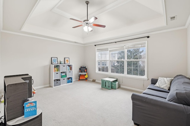 game room featuring a raised ceiling, crown molding, ceiling fan, and carpet flooring