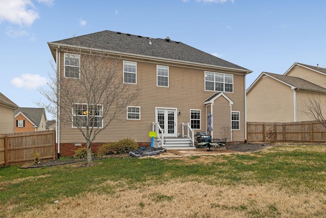 back of property featuring a yard and french doors