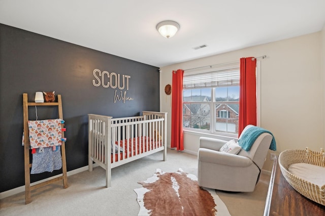 bedroom with carpet and a nursery area