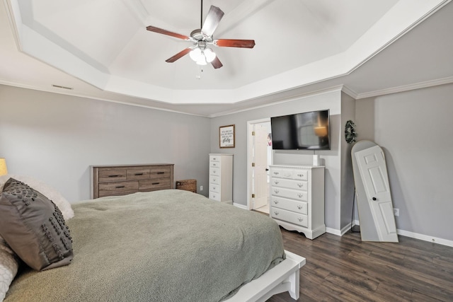 bedroom with a tray ceiling, dark wood-type flooring, and ceiling fan