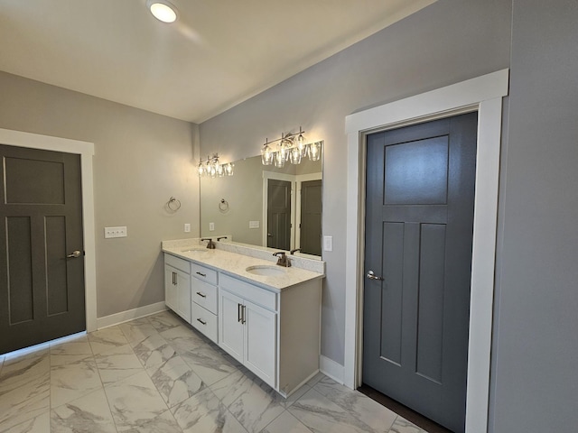 full bathroom featuring marble finish floor, baseboards, and a sink