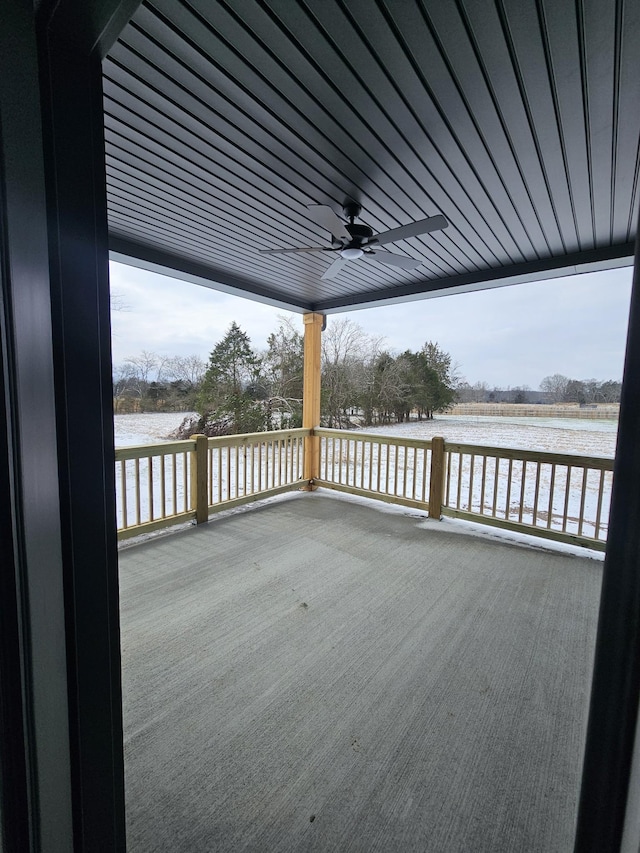 deck featuring ceiling fan and a rural view