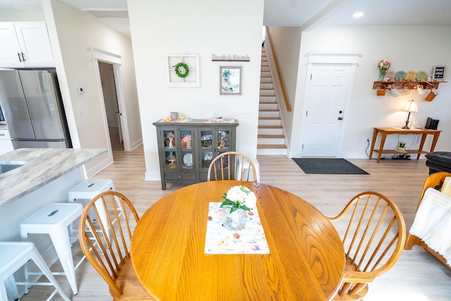 dining space with light hardwood / wood-style floors