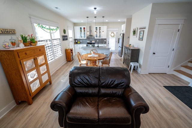 living room featuring sink and light hardwood / wood-style floors