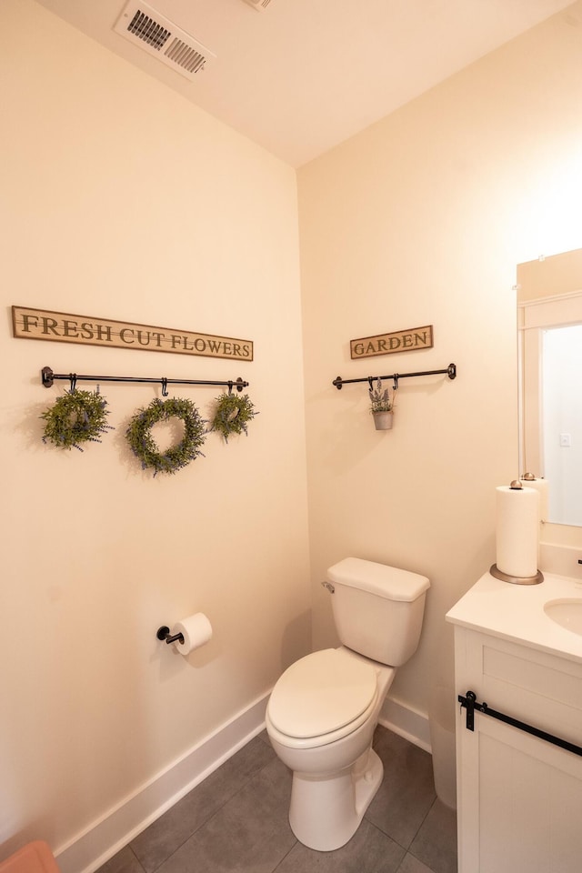 bathroom featuring tile patterned floors, toilet, and vanity