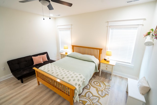 bedroom with ceiling fan and light hardwood / wood-style floors