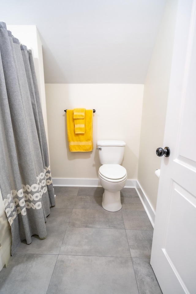 bathroom featuring toilet and lofted ceiling