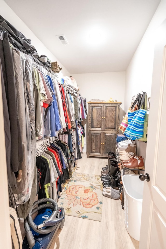 spacious closet with light hardwood / wood-style flooring