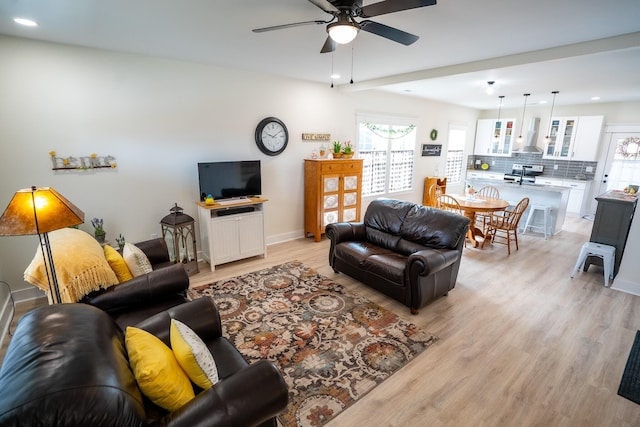 living room featuring ceiling fan and light wood-type flooring