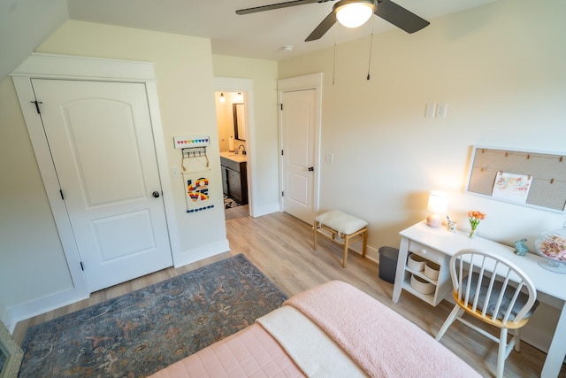 bedroom with ceiling fan, light hardwood / wood-style floors, and ensuite bathroom