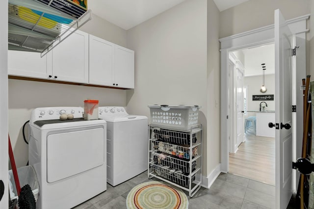 852 Pine Grove Rd, Ringgold, GA 30736 - laundry room featuring cabinet space, washer and dryer, and light tile patterned floors