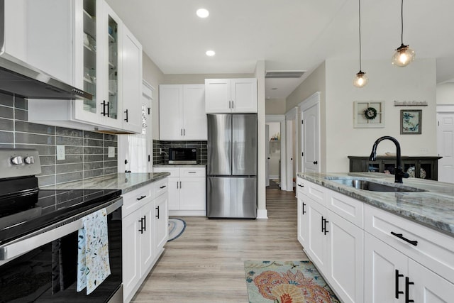 852 Pine Grove Rd, Ringgold, GA 30736 - kitchen with stainless steel appliances, a sink, wall chimney exhaust hood, light stone countertops, and backsplash