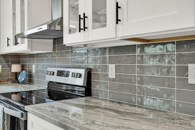 852 Pine Grove Rd, Ringgold, GA 30736 - kitchen featuring stainless steel electric stove, wall chimney exhaust hood, tasteful backsplash, and white cabinetry