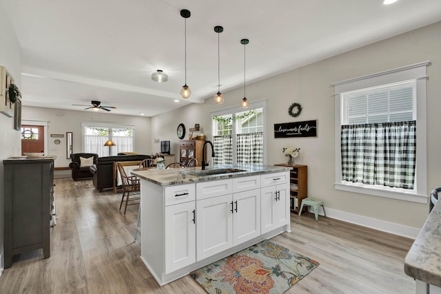 852 Pine Grove Rd, Ringgold, GA 30736 - kitchen with a sink, white cabinetry, light wood-style floors, decorative light fixtures, and light stone counters