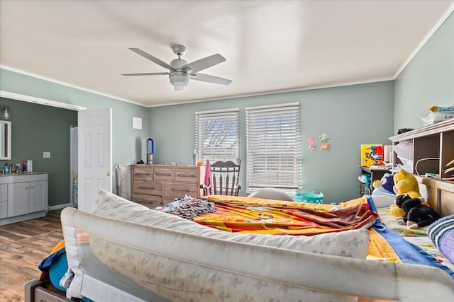 bedroom with hardwood / wood-style floors, ceiling fan, and ornamental molding