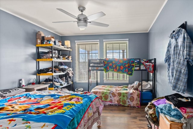 bedroom with ceiling fan, ornamental molding, and dark hardwood / wood-style floors