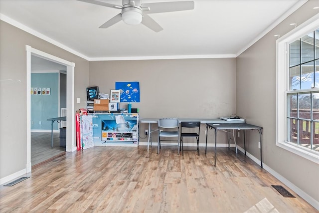 office area featuring light wood-type flooring, ornamental molding, and ceiling fan