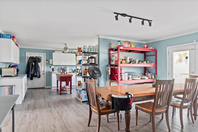 dining space featuring ornamental molding, ceiling fan, track lighting, and wood-type flooring