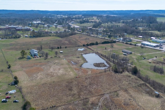 birds eye view of property with a rural view and a water view