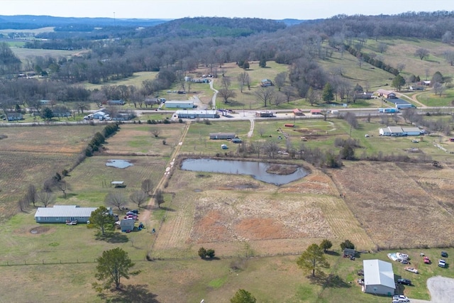 birds eye view of property featuring a rural view and a water view