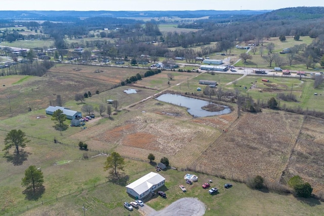 drone / aerial view featuring a water view and a rural view