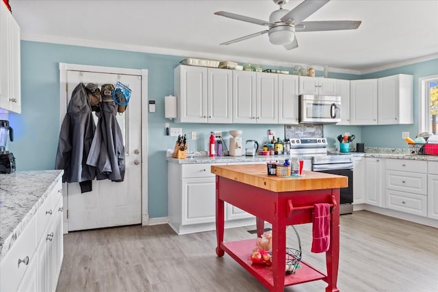 kitchen with stainless steel appliances, light hardwood / wood-style flooring, ceiling fan, light stone counters, and white cabinets