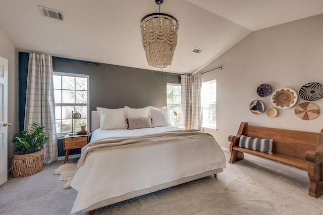 bedroom featuring multiple windows, vaulted ceiling, light colored carpet, and visible vents