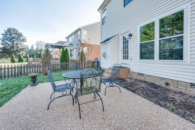 view of patio featuring outdoor dining space and fence