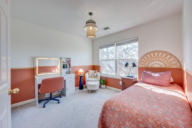 bedroom featuring baseboards, light colored carpet, and visible vents