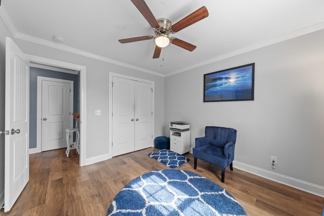 living area with ceiling fan, crown molding, and hardwood / wood-style floors