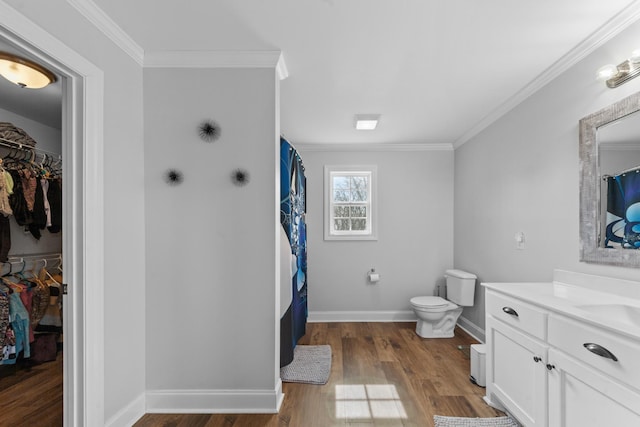 bathroom featuring wood-type flooring, a shower with curtain, vanity, and ornamental molding