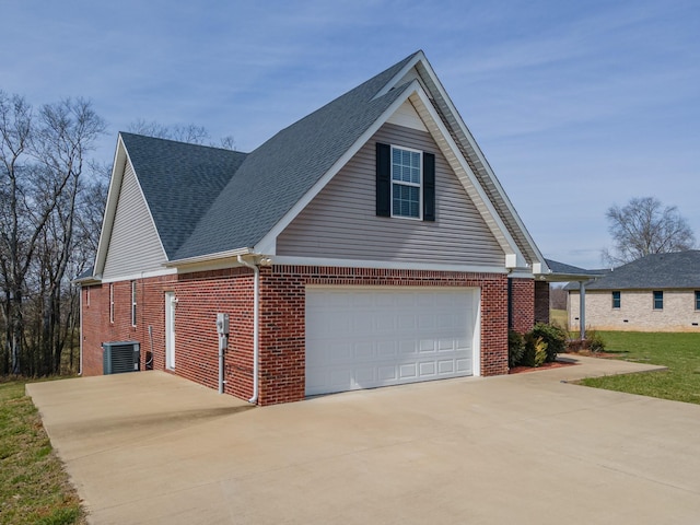 view of side of home featuring a garage and cooling unit