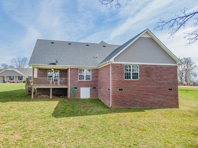 back of house featuring a yard and a wooden deck