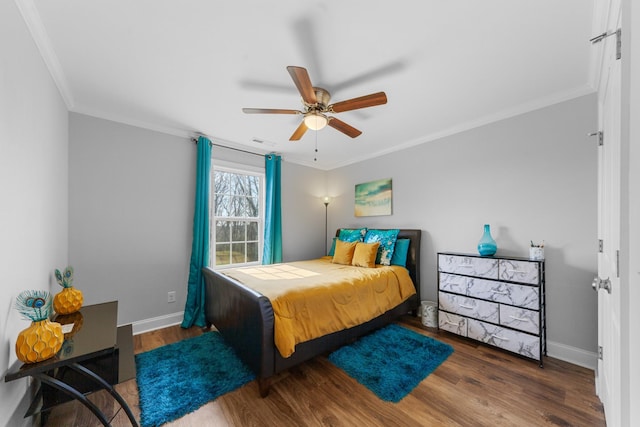 bedroom featuring crown molding, dark hardwood / wood-style flooring, and ceiling fan