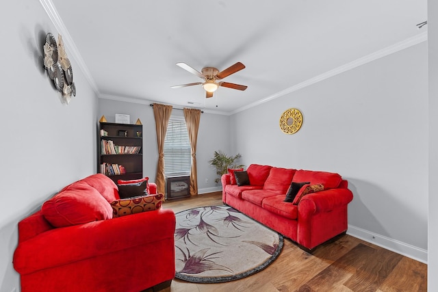 living room with hardwood / wood-style floors, ceiling fan, and ornamental molding