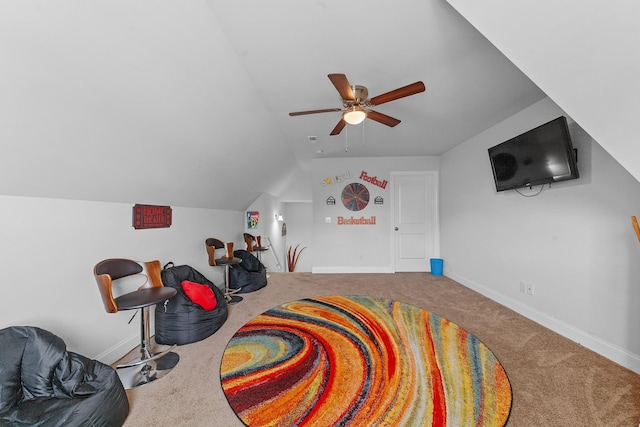 playroom featuring lofted ceiling, ceiling fan, and carpet flooring