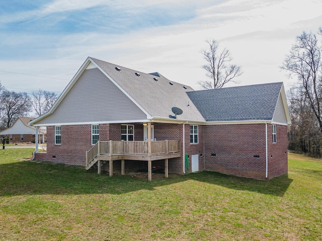 rear view of house featuring a deck and a lawn