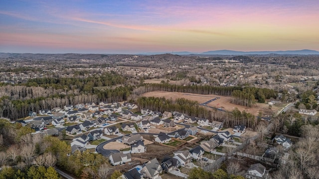 aerial view at dusk featuring a mountain view