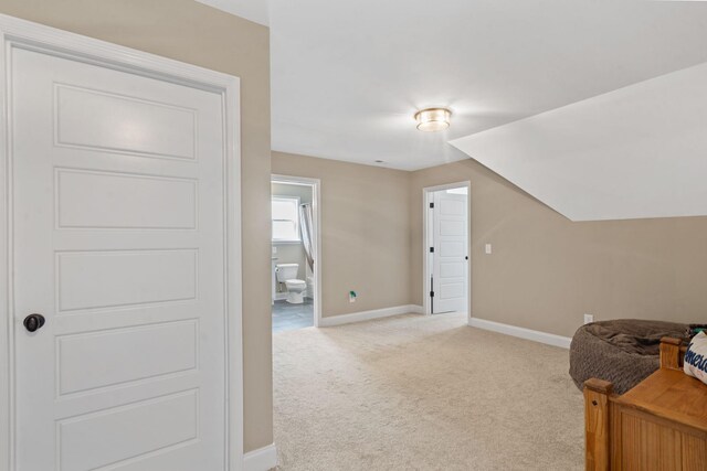 additional living space with lofted ceiling and light colored carpet